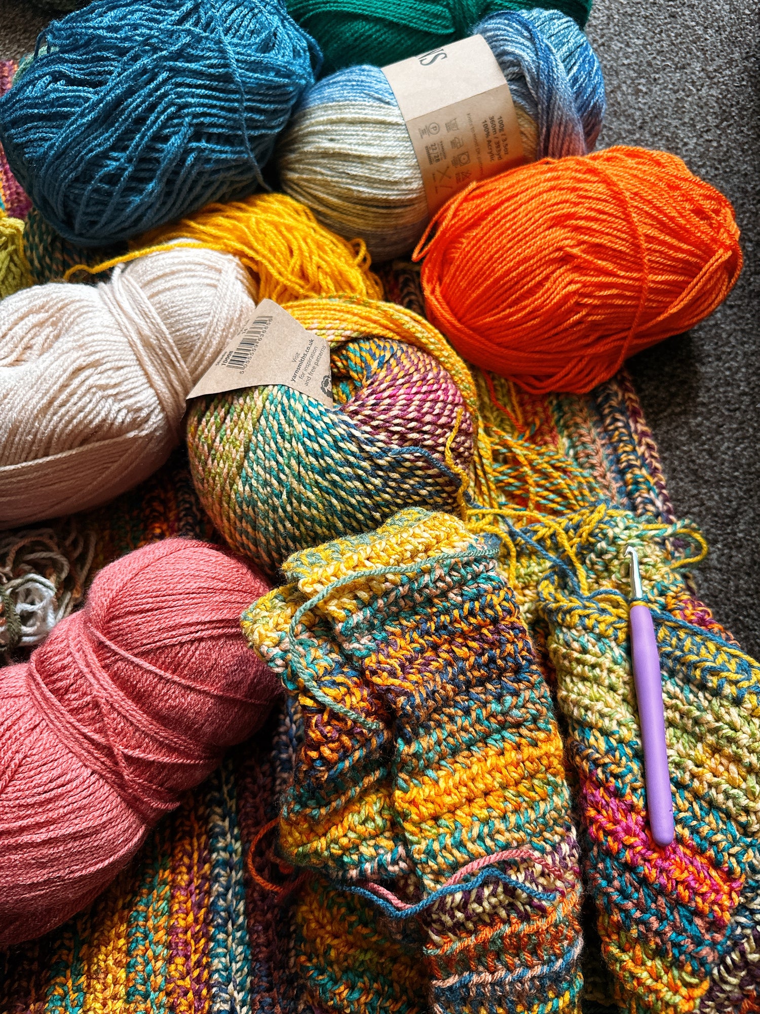 Creating Crochet Patterns with Lots of different colors yarns, and violet hook.