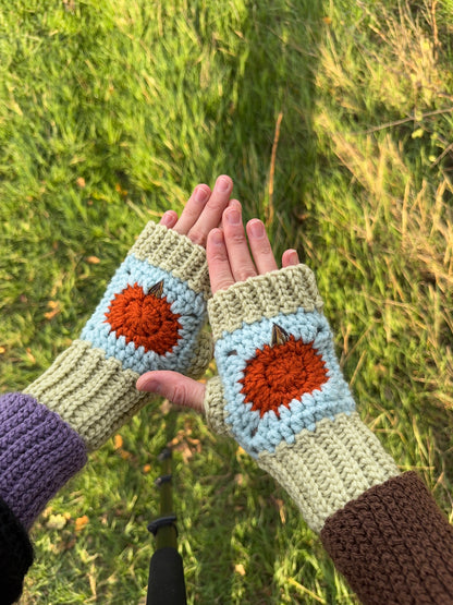 Pumpkin fingerless gloves crochet pattern – textured handmade wrist warmers in orange, blue and green colors. Easy beginner crochet project with a step-by-step photo guide.