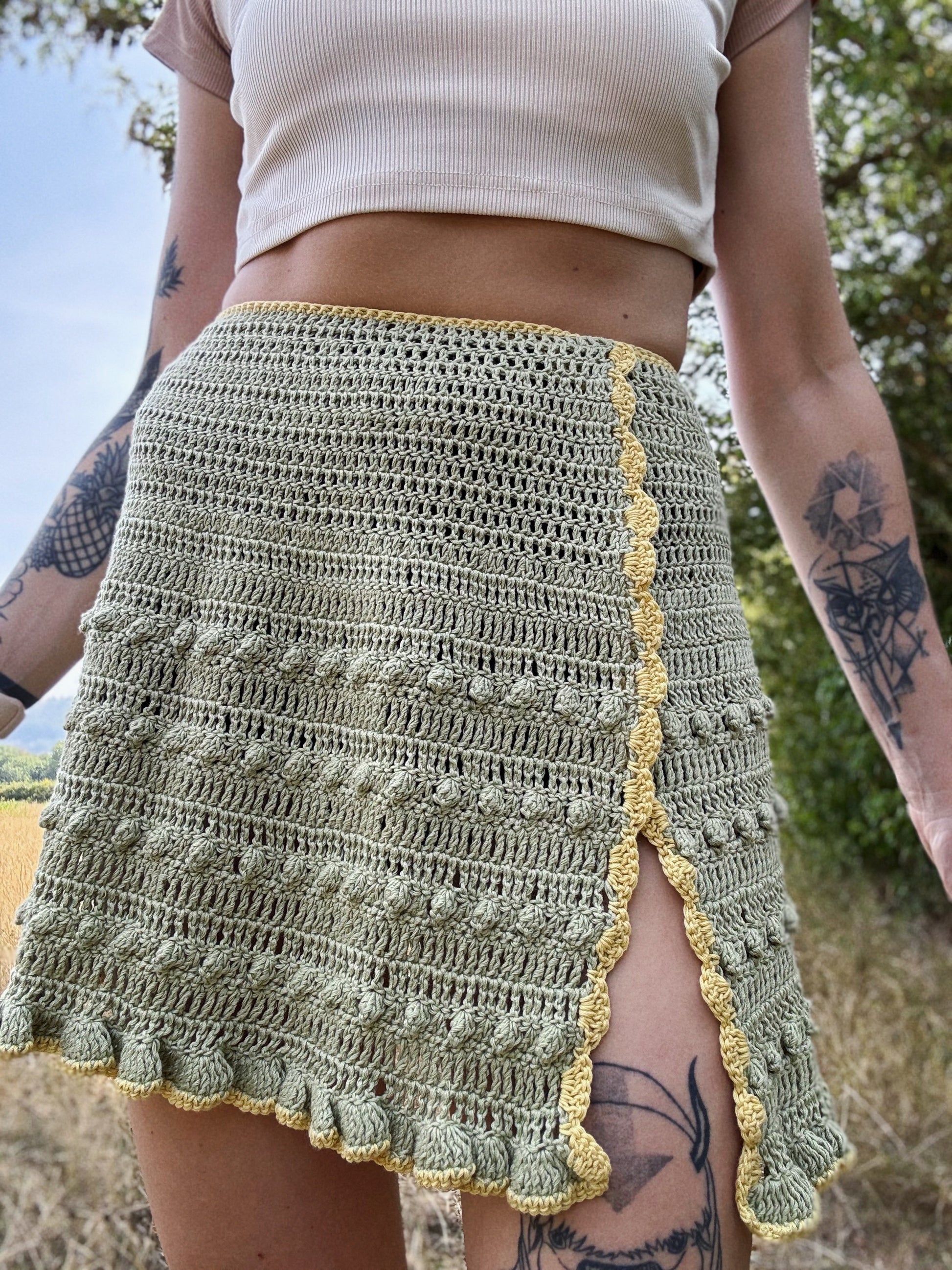 Boho-style crochet skirt pattern with tie waist for beachwear in green color, beginner friendly, customizable crochet pattern.